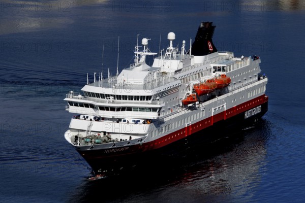 Hurtigruten ship on calm seas in sunny weather near Hammerfest, Hammerfest, Finnmark, Norway