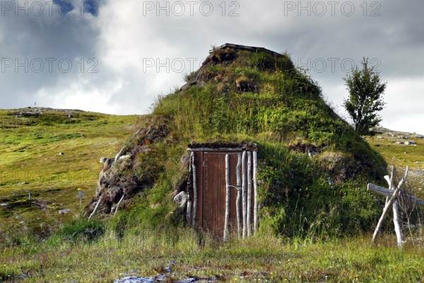 A traditional moss-covered seed hut in the countryside near Hammerfest, Hammerfest, Finnmark, Norway