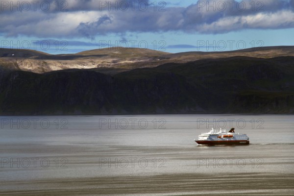 Hurtigruten ship off the coast at Hammerfest, calm seas under cloudy sky, Hammerfest, Finnmark, Norway