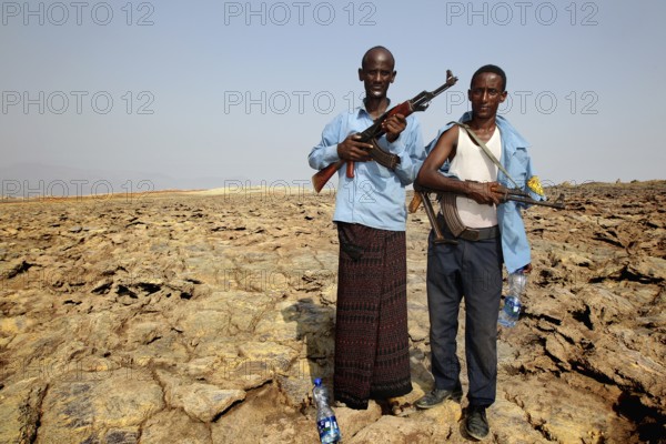 Two policemen with guns in the geothermal area of Dallol, hot climate, Dallol, Ethiopia