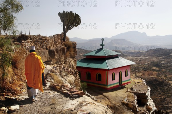 Monk wanders past grave church with breathtaking views, Debre Damo, Tigray, Ethiopia