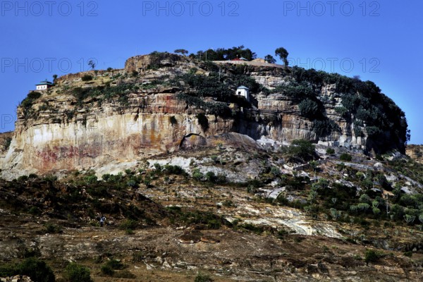 A monastery perched on a wooded plateau under clear skies, Debre Damo, Tigray, Ethiopia