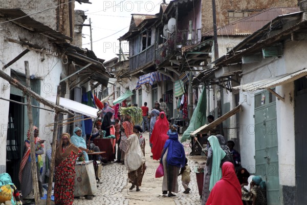 Lively tailor's alley in the old town of Harar filled with people wearing traditional clothes, Harar, Harari, Ethiopia
