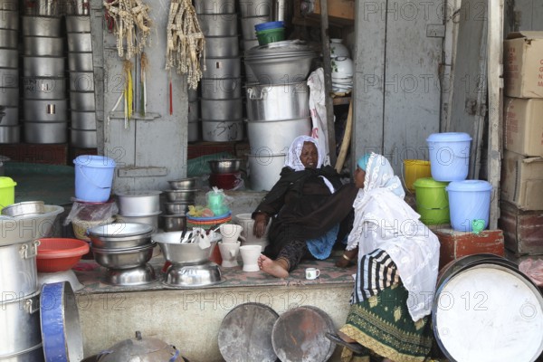 Traditional shop stand in the old town of Harar with kitchenware and colorful buckets, Harar, Harari, Ethiopia