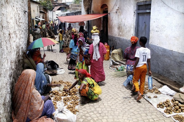 Market scene in an alley in Harar with colorful clothes and goods, Harar, Ethiopia