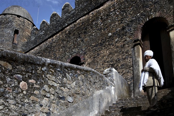 Castle stone staircase with traditionally dressed person at the entrance in Gondar, Gondar, Amhara, Ethiopia
