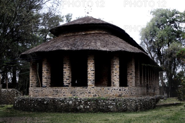 Stone church with round roof and columns in Debre Berhan Selassie