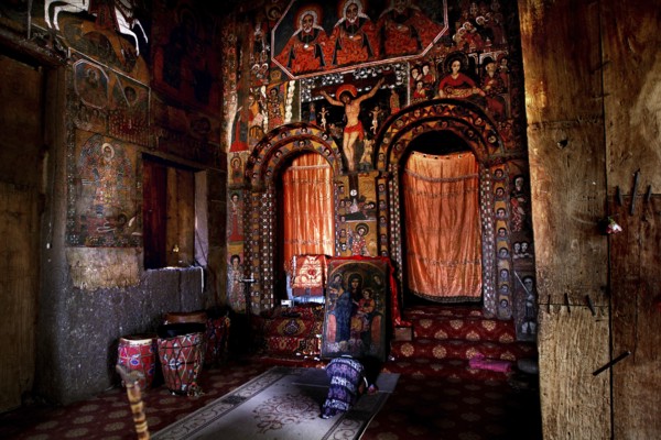 Interior view by Debre Berhan Selassie with wall paintings and symmetrical doors