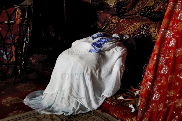 Worshippers inside Debre Berhan Selassie church, wrapped in cloth, in Gondar, Gondar, Ethiopia