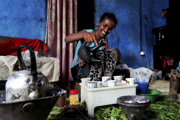 Woman serves coffee in traditional ceremony in Lalibela, Lalibela, zero