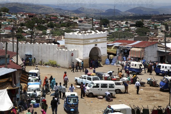 The Shoa Ber West Gate of Harar surrounded by busy markets and vehicles, Harar, Harari, Ethiopia