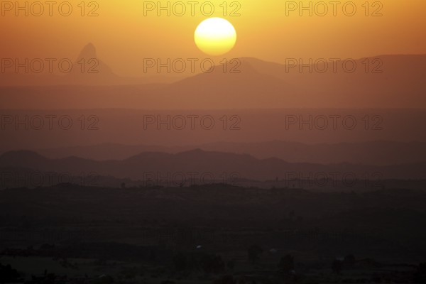 Sunset over a hilly landscape with intense warm colors, Hawzien, Gheralta, Ethiopia