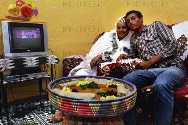 Visiting Worknesh with traditional food in a cozy living room, Lalibela, Ethiopia