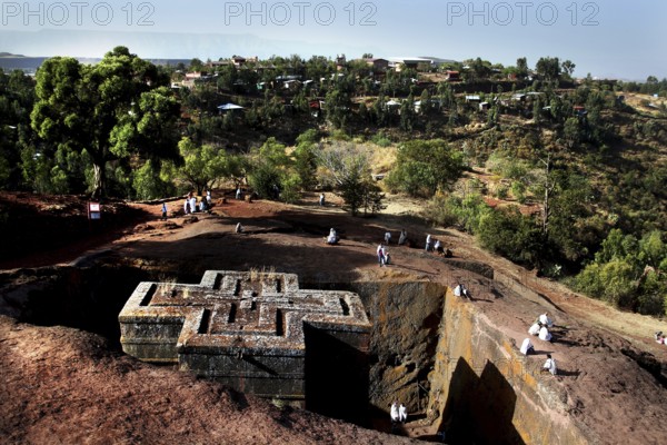 Aerial view of Bete Gyorgis surrounded by nature and pilgrims, Lalibela, Amhara, Ethiopia