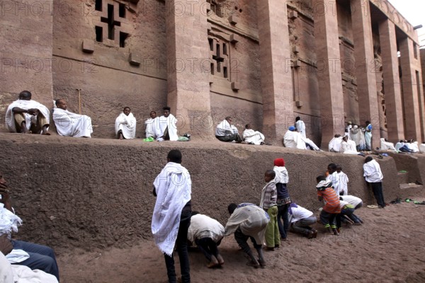 Believers in white robes pray at Bete Medhane Alem church during Easter, Lalibela, Amhara, Ethiopia