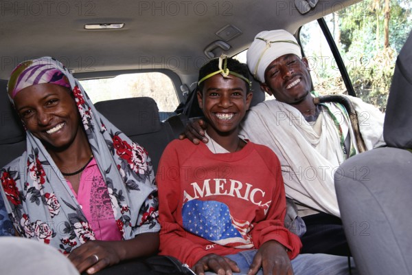 Three happy people in a Landcruiser in the Lasta Mountains. Modernity and tradition combined, Lalibela, Amhara, Ethiopia