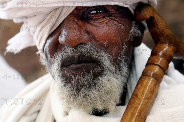 Portrait of an elderly man wearing a turban, deep in thought, Lalibela, Amhara, Ethiopia