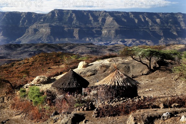 Traditional round huts against the majestic backdrop of the Lasta Mountains, Lalibela, Amhara, Ethiopia