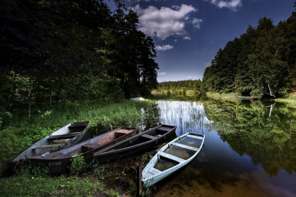 Three boats on quiet lakeside in Zemaitija National Park