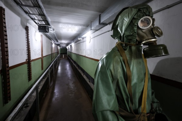 A walk in the Zemaitija National Park bunker with a figure wearing a protective suit, Plokstine, Zemaitija, Lithuania