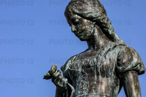 Detailed view of the Änchen von Tharau sculpture against a blue sky in Klaipeda, Klaipeda, Memel, Lithuania