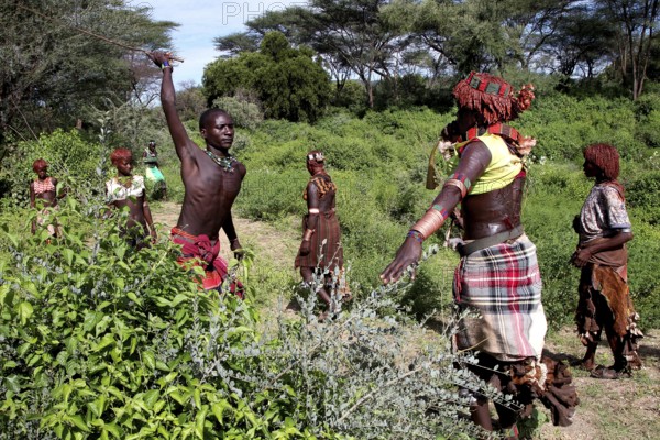 Hamer woman in a traditional initiation scene, with a focus on a flogging, Turmi, Ethiopia