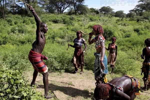 A group of Hamer woman perform a flogging, part of their initiation ceremony, Turmi, Ethiopia