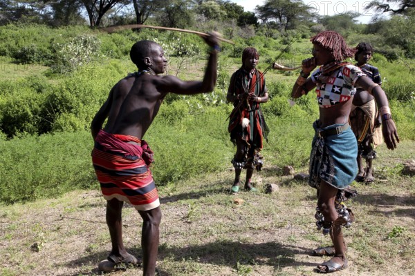 Hamer woman whipping, part of a ceremonial initiation ritual, in the nature of Turmi, Turmi, Ethiopia
