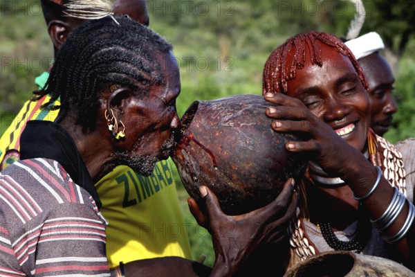 Hamer community shares beer during an initiation ritual, Turmi, Ethiopia
