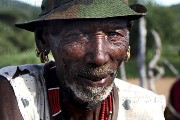 Portrait of a Hamer man wearing hat and traditional jewelry, Turmi, Ethiopia