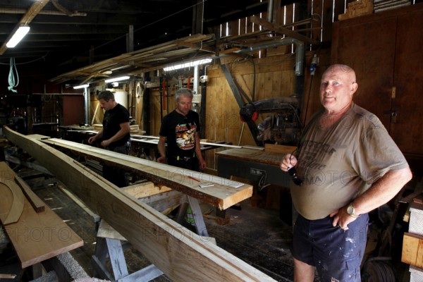 Shipyard workers work in a wood-paneled workshop in Kristiansund, Kristiansund, Norway