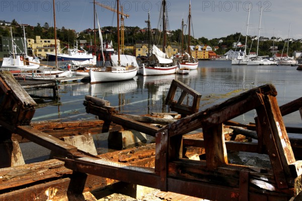Mellemværftet shipyard in Kirkelandet with sailboats and old wooden parts in the foreground, Kristiansund, Møre og Romsdal, Norway