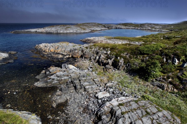 Rugged rocky coast with views from Eldhusøya across the sea near Lyngholmen, Atlanterhavsveien, Norway