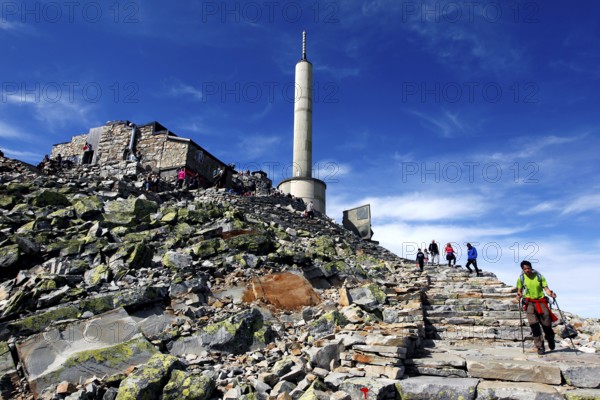 The ascent to the Gaustatoppen summit plateau, rock trails lead to the distinctive tower, zero