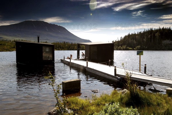 View of the lake from Gaustablikk with jetty and sauna, rolling mountains in the background, zero