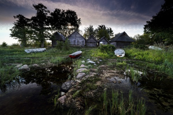 Fishing sheds and boats on the quiet beach of Altja at dusk, Altja, Estonia