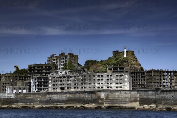 Abandoned building on Gunkanjima island with dramatic sky in the background, Nagasaki, Kyushu, Japan
