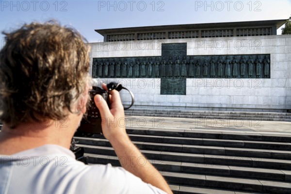 Martyr memorial with a photographer in the foreground, steps leading to the impressive building, Nagasaki, Kyushu, Japan