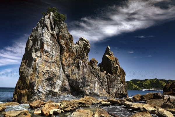 Weather-eroded rocks on the coast under a cloudy sky, Kushimoto, Wakayama, Japan