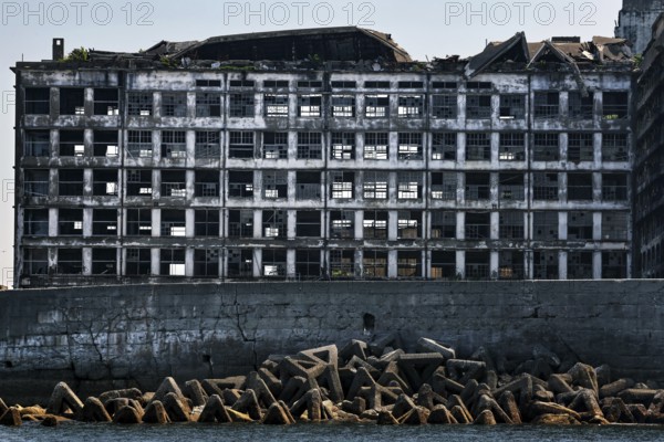 Close-up of dilapidated building structures on Gunkanjima reflecting history and decay, Nagasaki, Kyushu, Japan