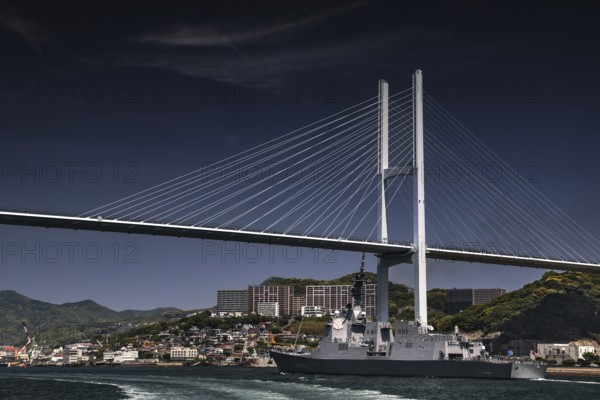 Modern bridge across the sea with a warship and urban background, Nagasaki, Nagasaki, Japan