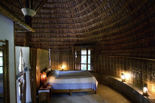 Cozy room at Aregash Lodge with thatched roof and wooden furniture, Yirga Alem, Ethiopia