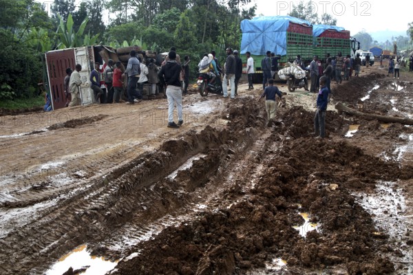 Poor road conditions with trucks waiting and people in the mud, Yirga Alem route, Yabello, Ethiopia