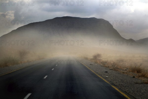 Road in a sandstorm in front of a mountain in Shehet, Shehet, Ethiopia