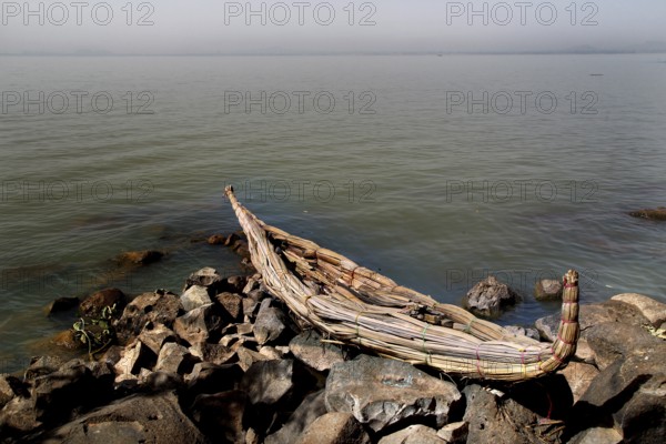 Papyrus boat is lying on the rocks on the shores of Lake Tana, zero