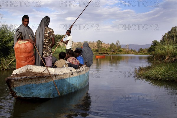 Ferry with people on a river against a scenic backdrop, Blue Nile, Ethiopia
