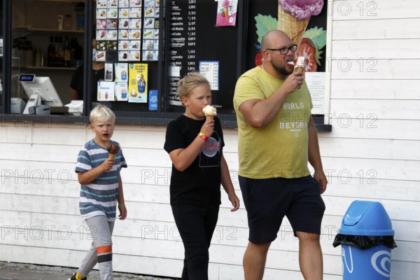 Family enjoying ice cream in front of an ice cream shop in Porvoo, Porvoo, Finland