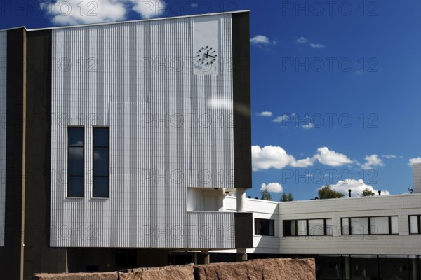 Modern town hall building with typical Alvar Aalto architecture under blue sky, Rovaniemi, Finland