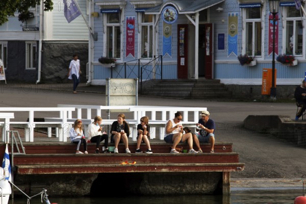 People enjoying ice cream on the banks of Naantali, Naantali, Finland