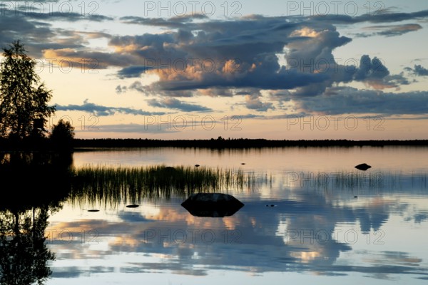 Tranquility and picturesque sunset over a lake in Lapland, Lapland, Finland